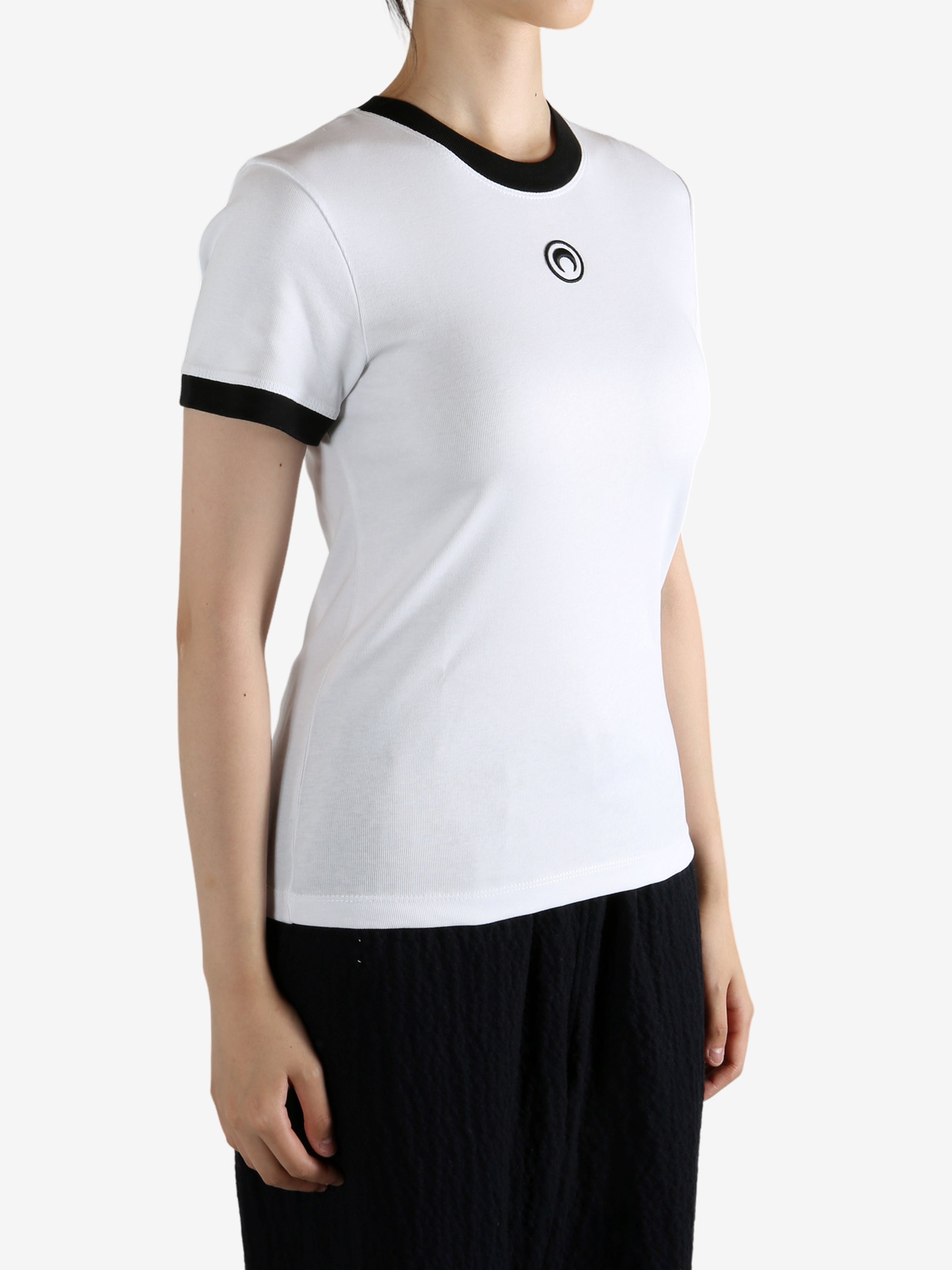 White t-shirt worn by a person, showing the shirt's fit