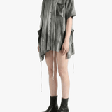 Grey top worn by a person, side view