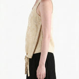 Tan tops worn by a person, showing the tops fit