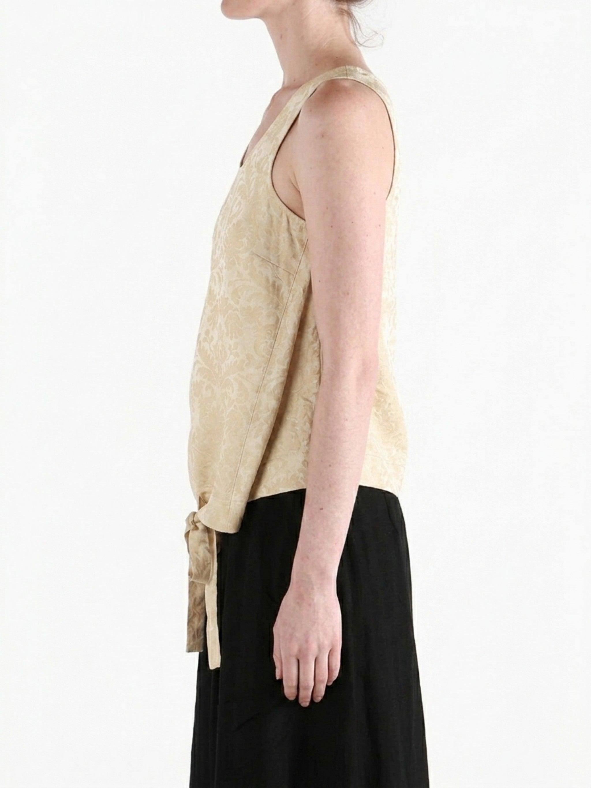 Tan tops worn by a person, showing the tops fit