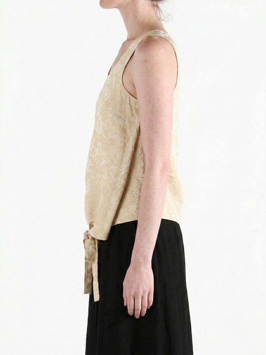 Tan tops worn by a person, showing the tops fit