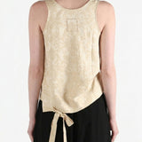 Tan tops worn by a person, showing the tops fit