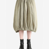 Tan skirt worn by a person, showing the skirt fit