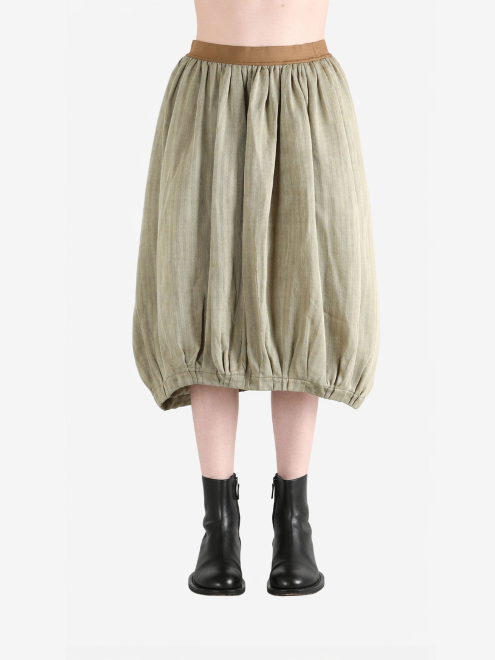 Tan skirt worn by a person, showing the skirt fit