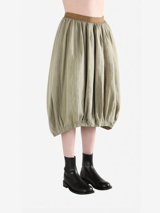 Tan skirt worn by a person, side view