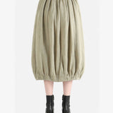 Tan skirt worn by a person, back view