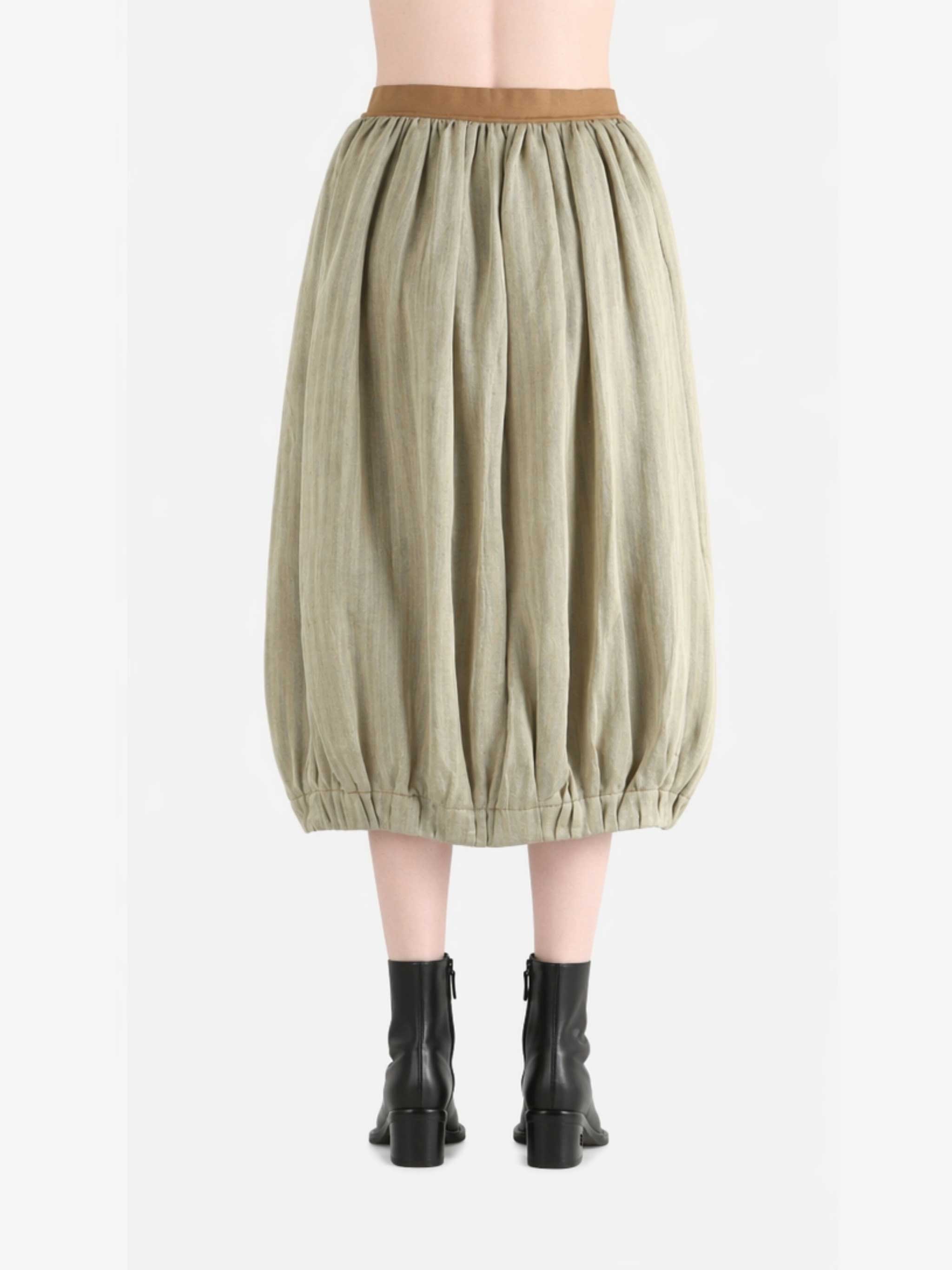 Tan skirt worn by a person, back view