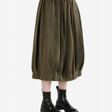 Brown skirt worn by a person, side view