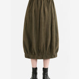 Brown skirt worn by a person, back view
