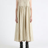 Tan dress worn by a person, showing the dress fit