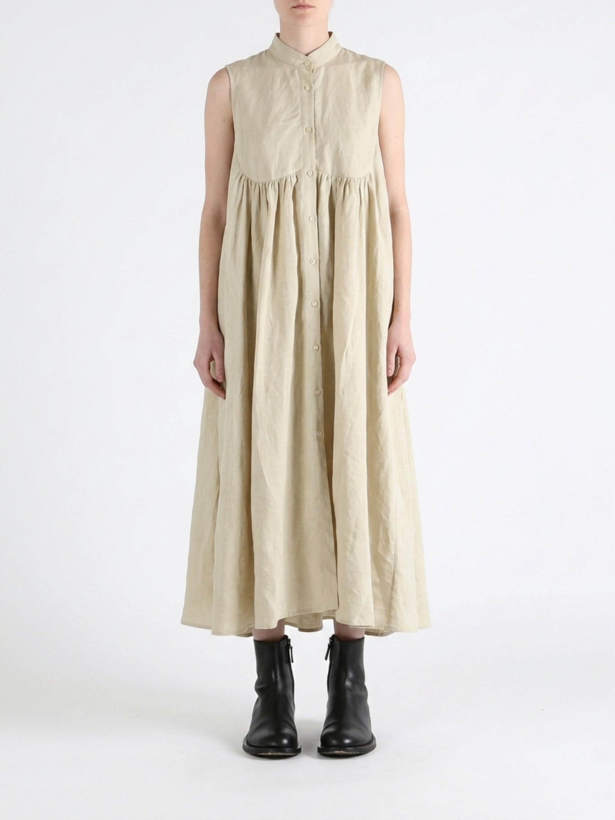 Tan dress worn by a person, showing the dress fit