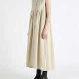 Tan dress worn by a person, side view