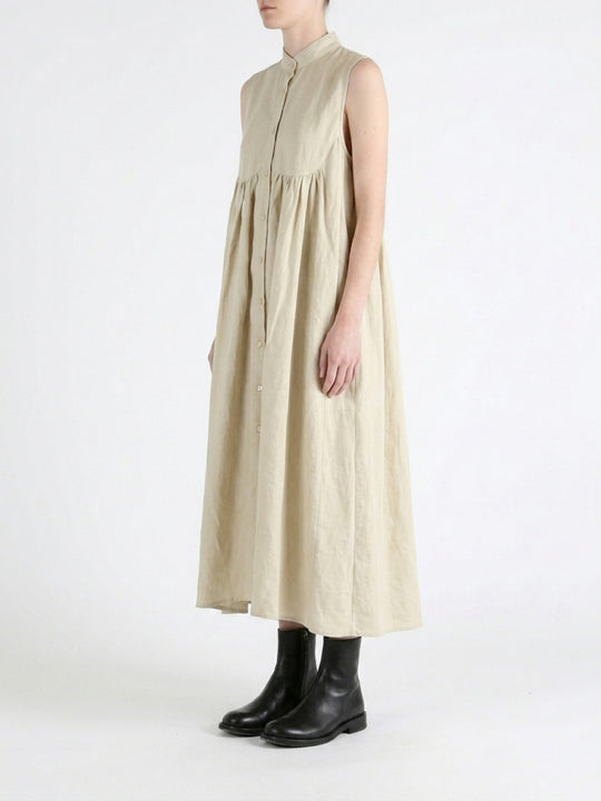 Tan dress worn by a person, side view