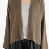 Brown jacket worn by a person, showing the jacket's fit