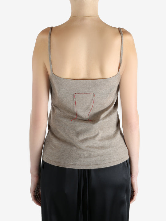 Tan knitwear worn by a person, showing the knitwear fit