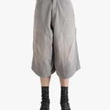 Grey shorts worn by a person, showing the shorts' fit