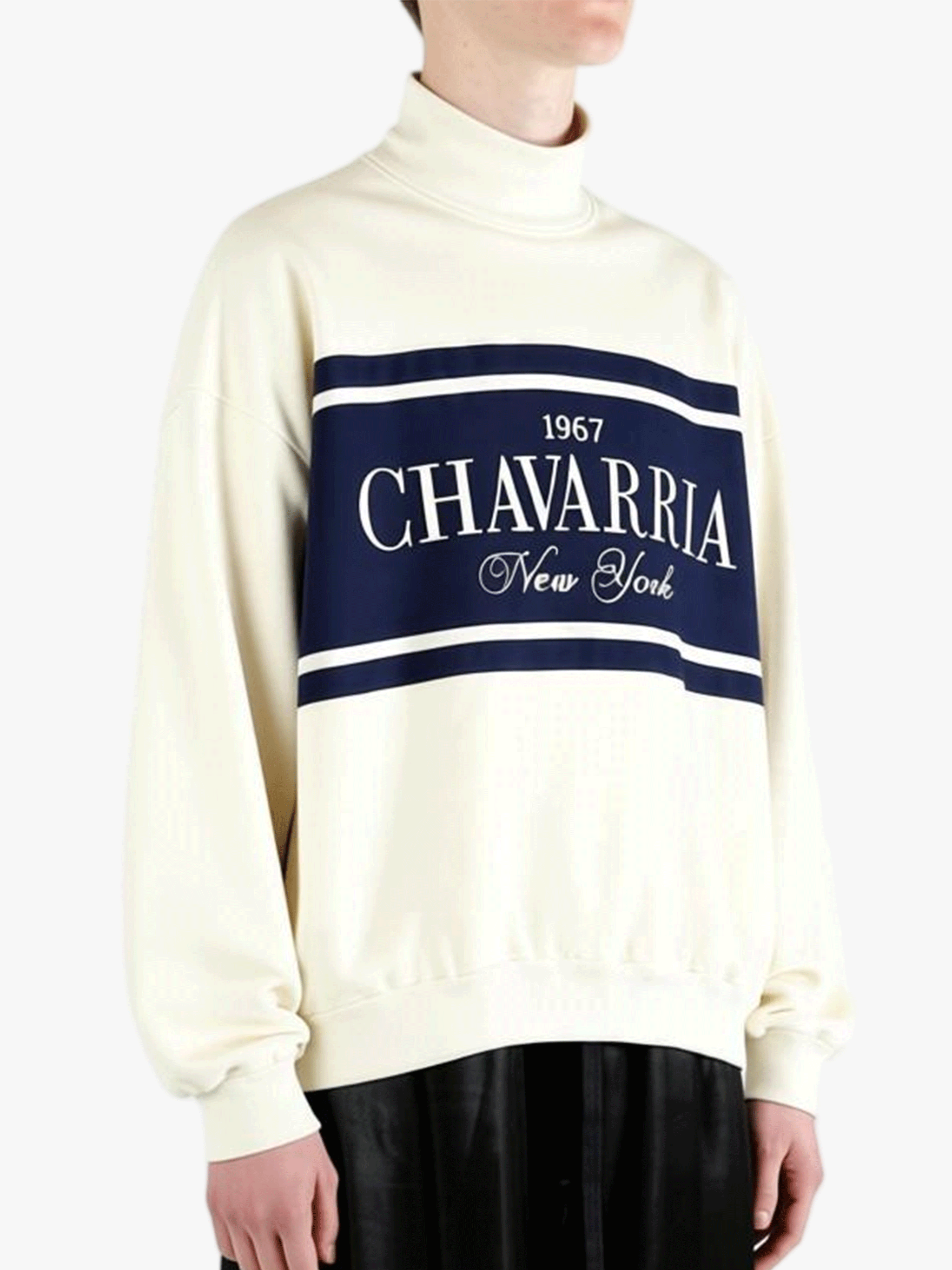 White knitwear worn by a person, showing the knitwear's fit