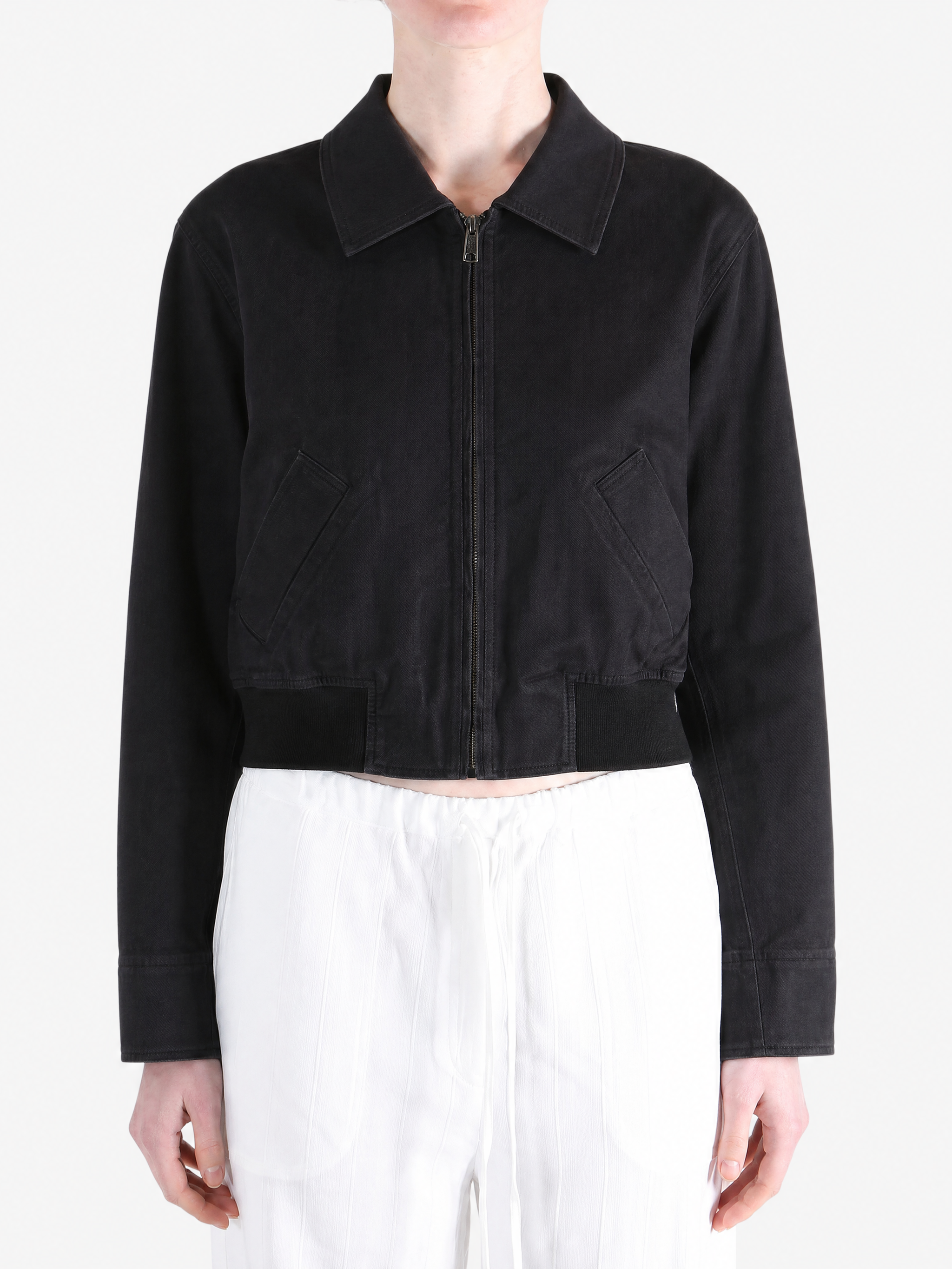 Black coat worn by a person, showing the coat fit