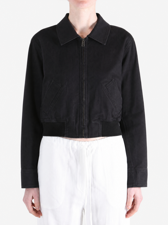 Black coat worn by a person, showing the coat fit