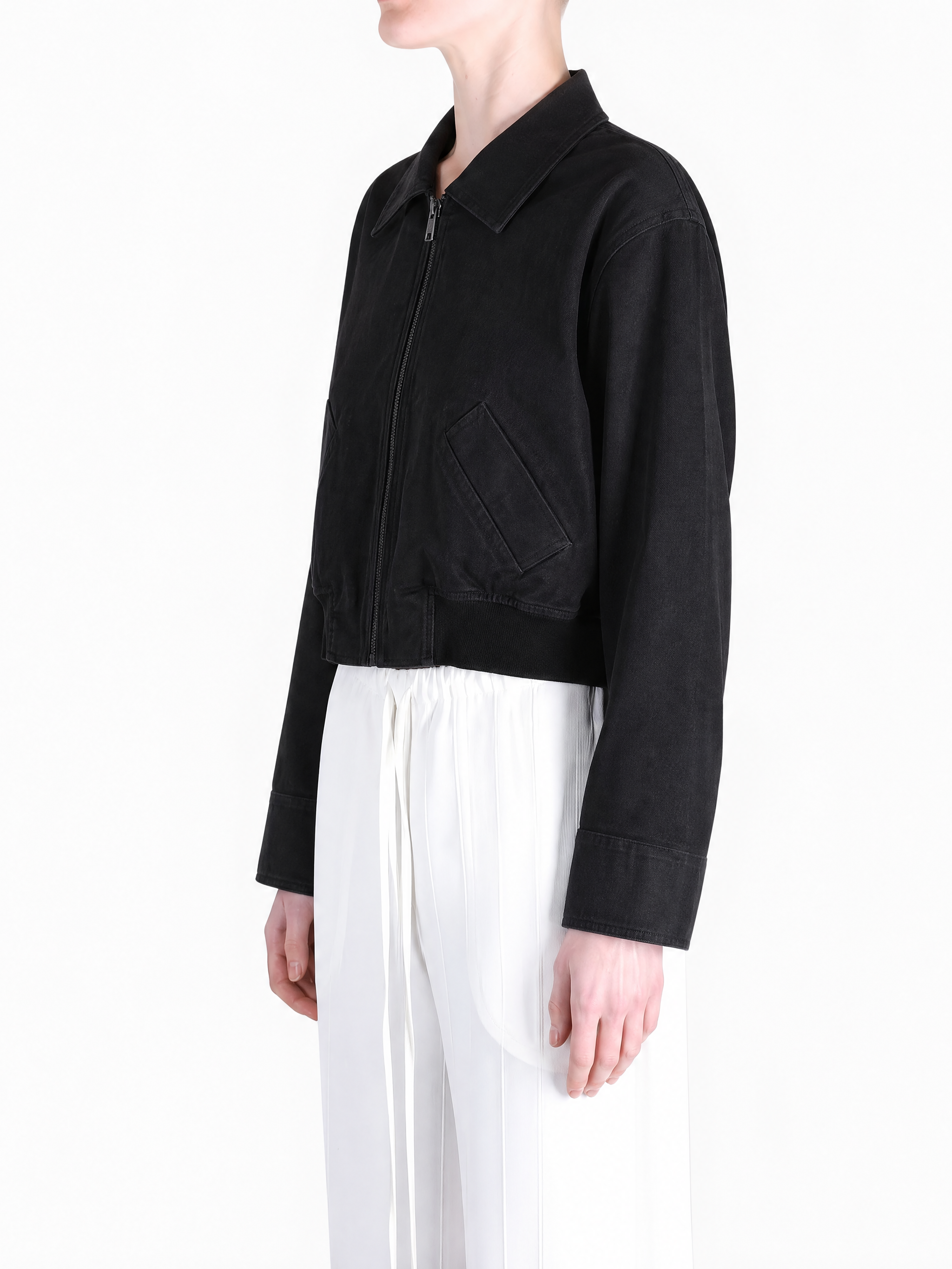 Black coat worn by a person, showing the coat fit