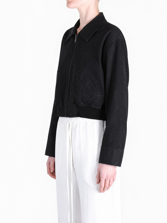 Black coat worn by a person, showing the coat fit
