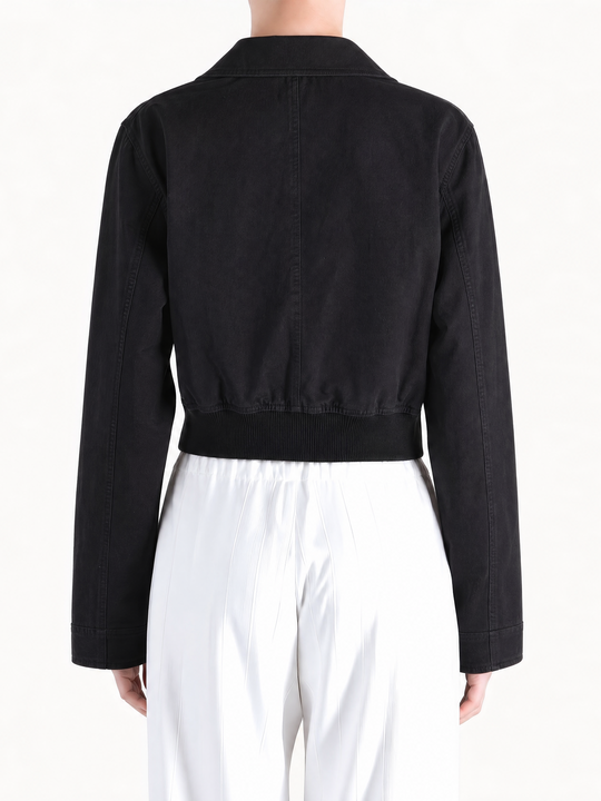 Black coat worn by a person, showing the coat fit