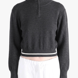 Black knitwear worn by a person, showing the knitwear fit
