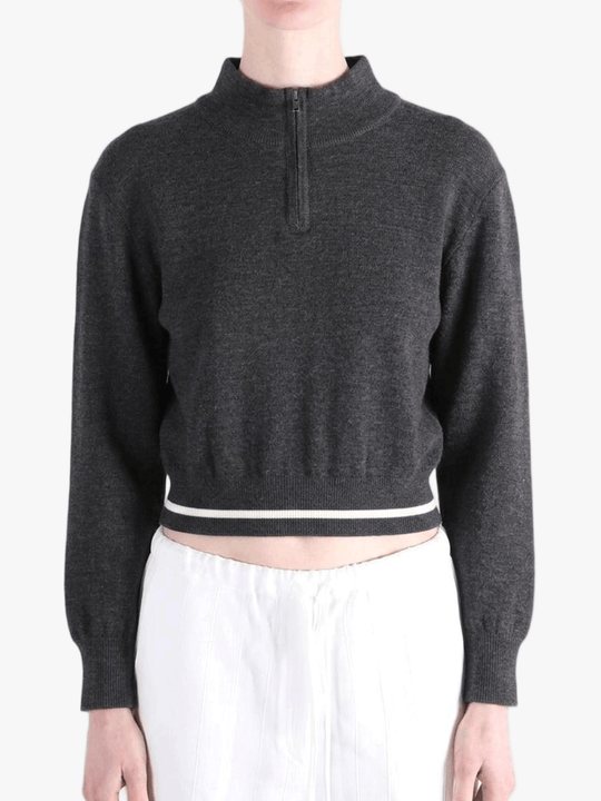 Black knitwear worn by a person, showing the knitwear fit
