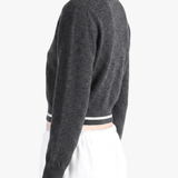 Black knitwear worn by a person, side view