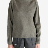 Grey knitwear worn by a person, showing the knitwear fit