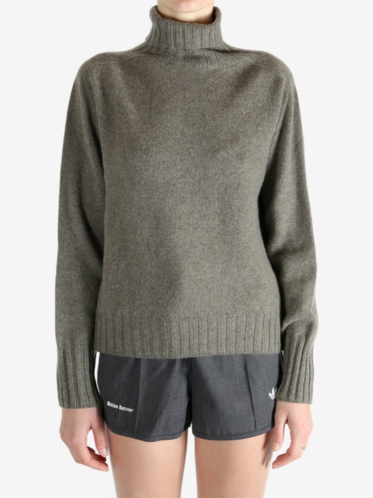 Grey knitwear worn by a person, showing the knitwear fit