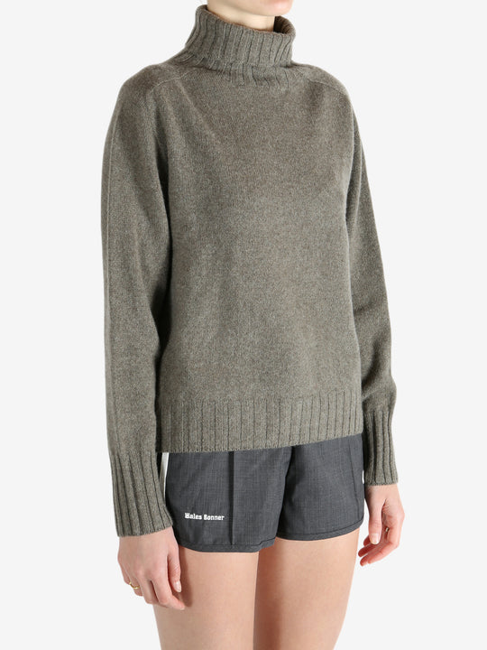 Grey knitwear worn by a person, showing the knitwear fit