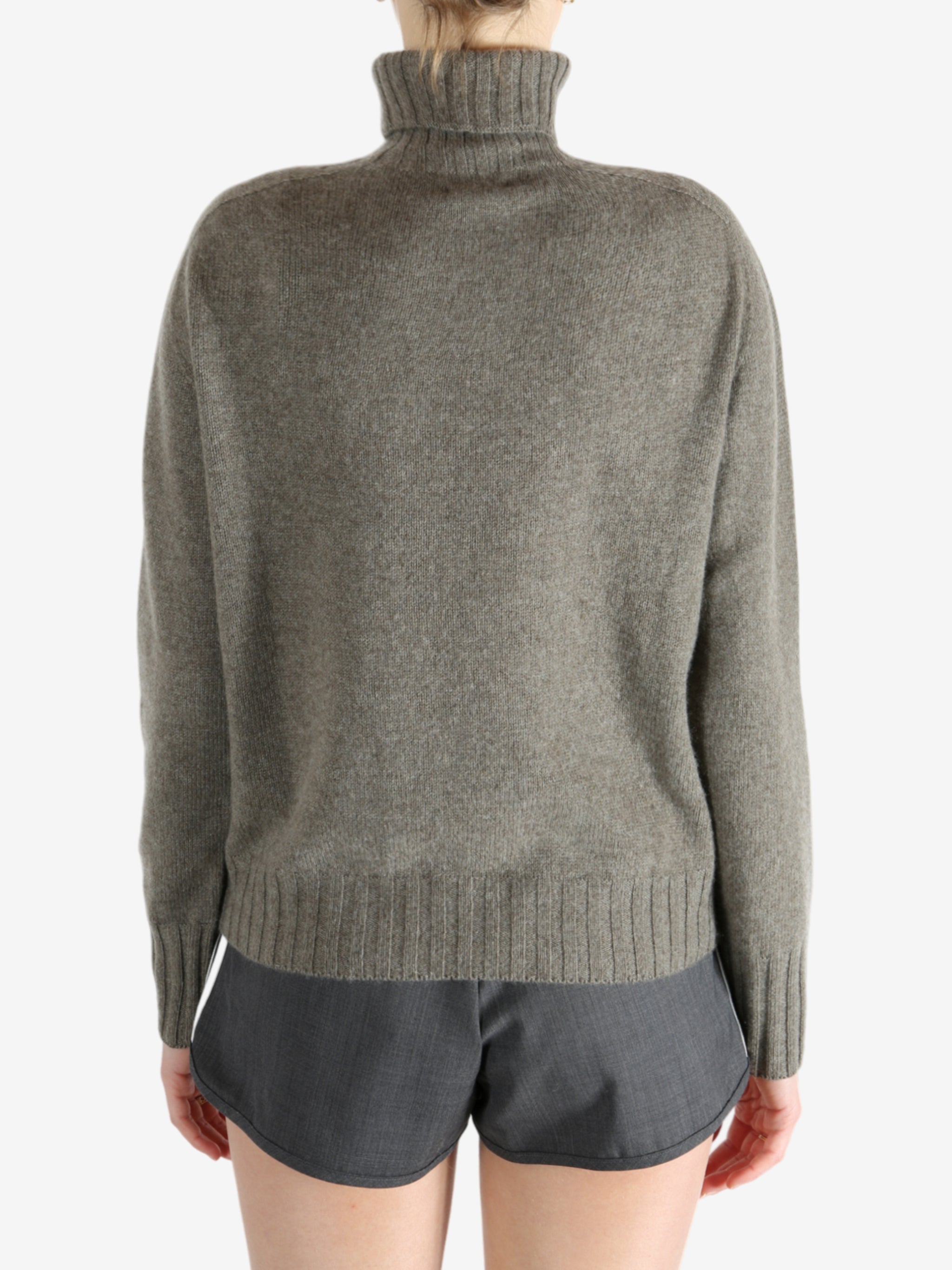 Grey knitwear worn by a person, showing the knitwear fit
