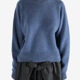 Navy knitwear worn by a person, showing the knitwear's fit