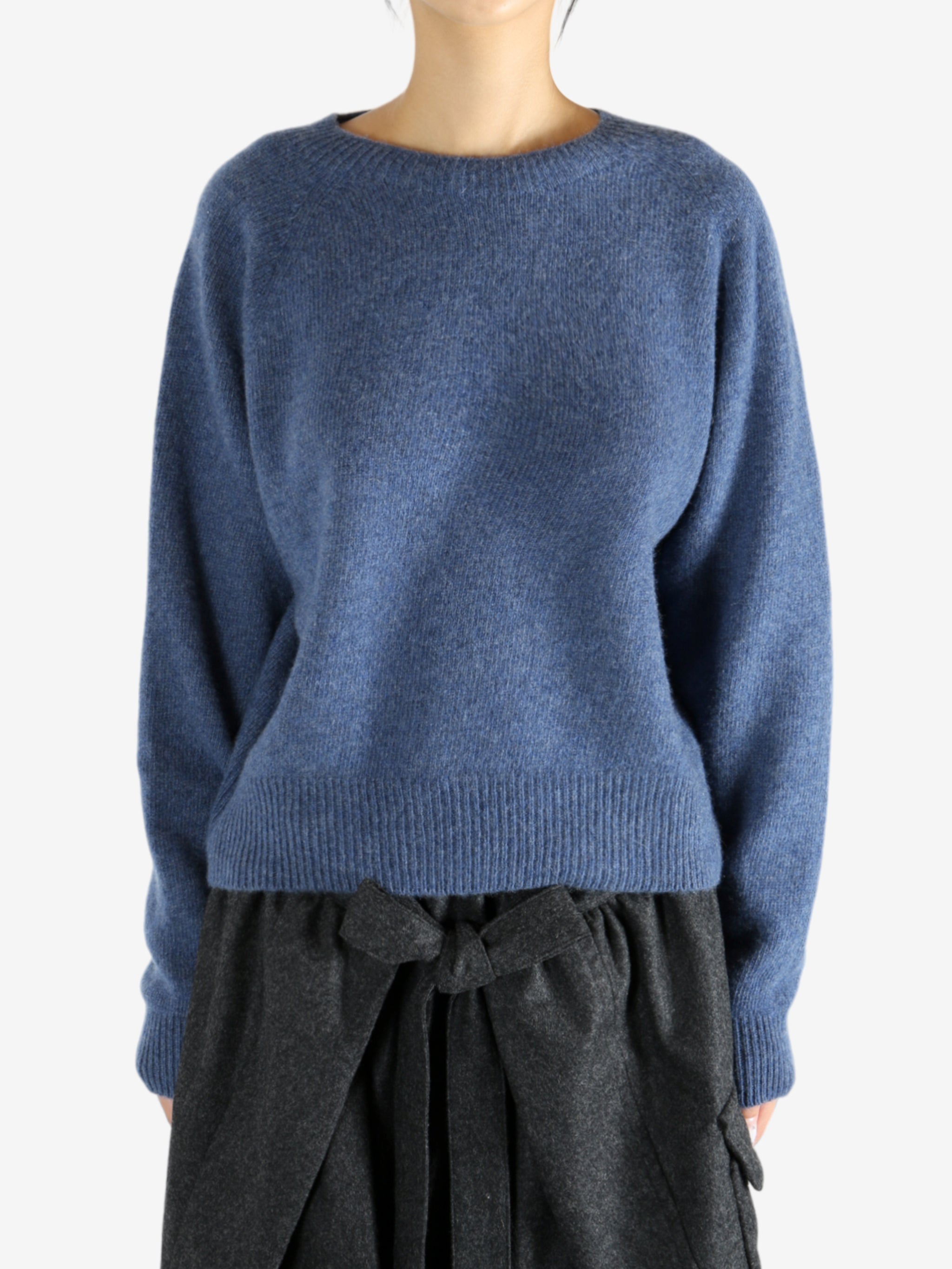 Navy knitwear worn by a person, showing the knitwear's fit