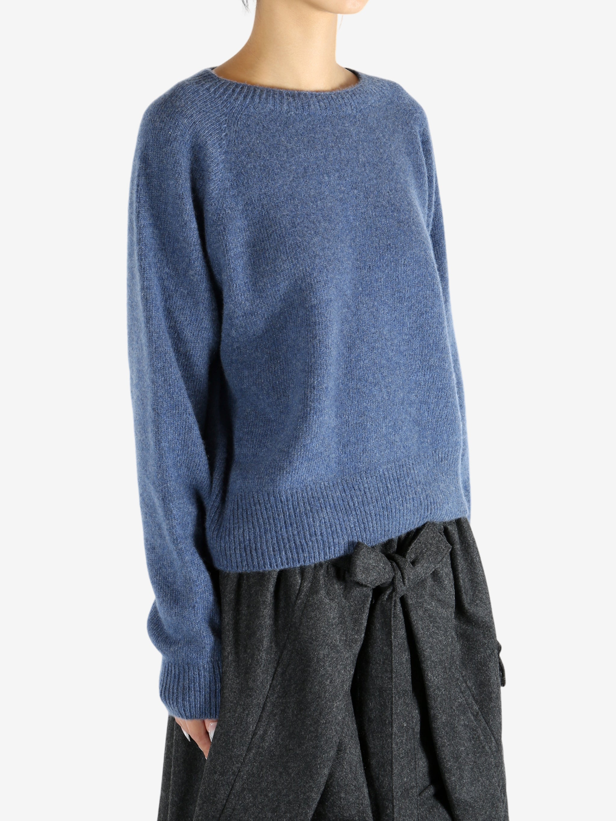 Navy knitwear worn by a person, showing the knitwear's fit