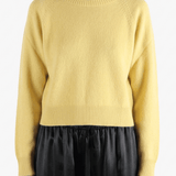 Yellow knitwear worn by a person, showing the knitwear's fit