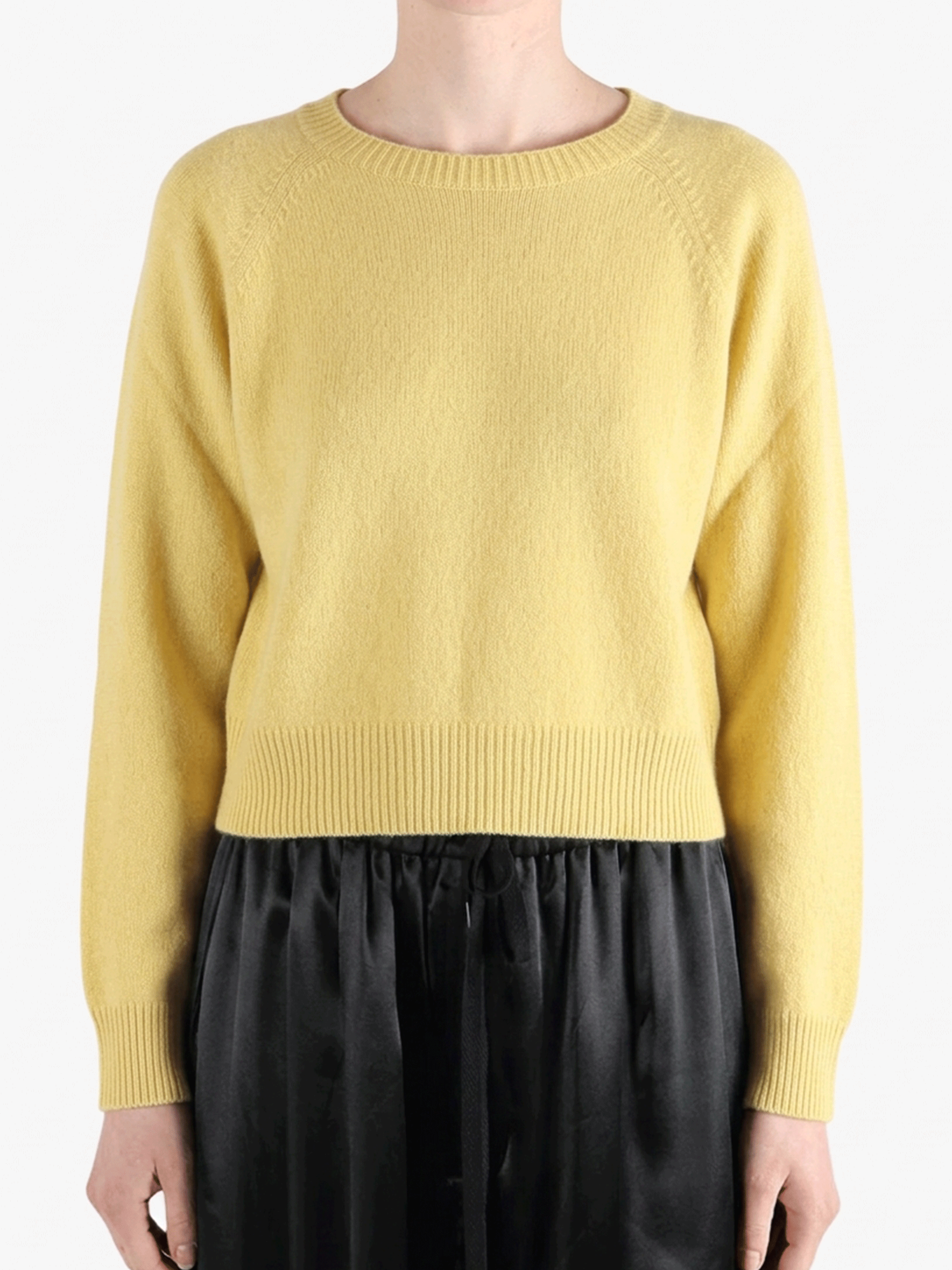 Yellow knitwear worn by a person, showing the knitwear's fit