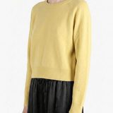 Yellow knitwear worn by a person, showing the knitwear's fit
