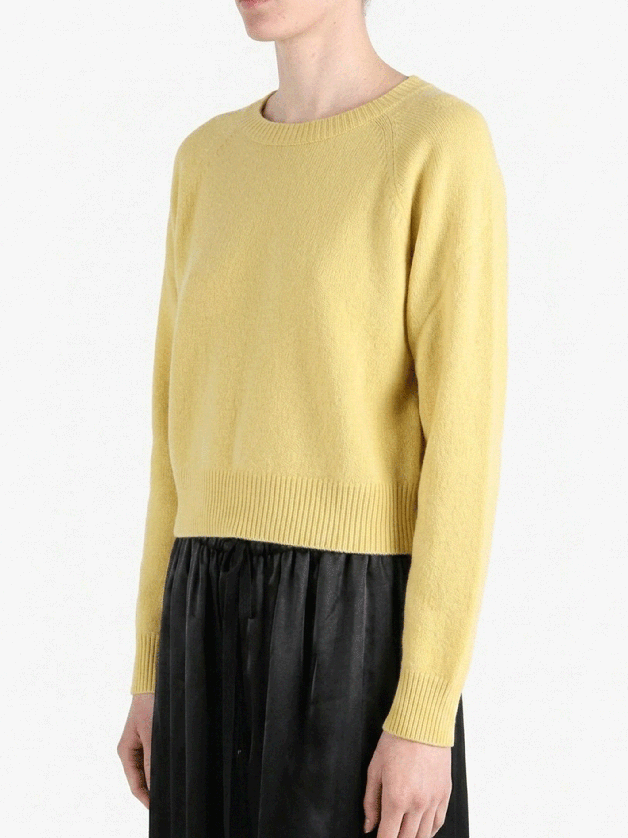 Yellow knitwear worn by a person, showing the knitwear's fit