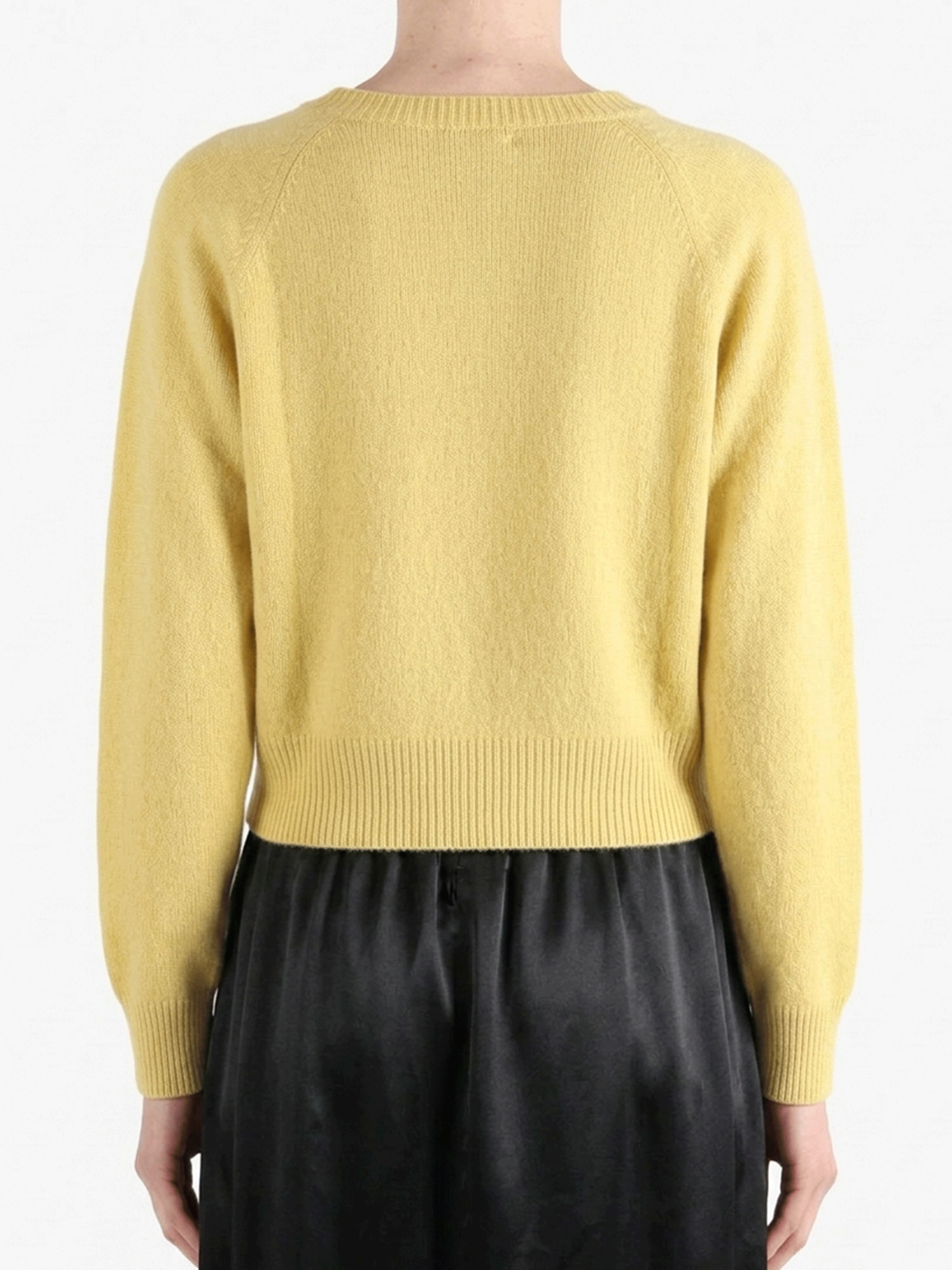 Yellow knitwear worn by a person, showing the knitwear's fit
