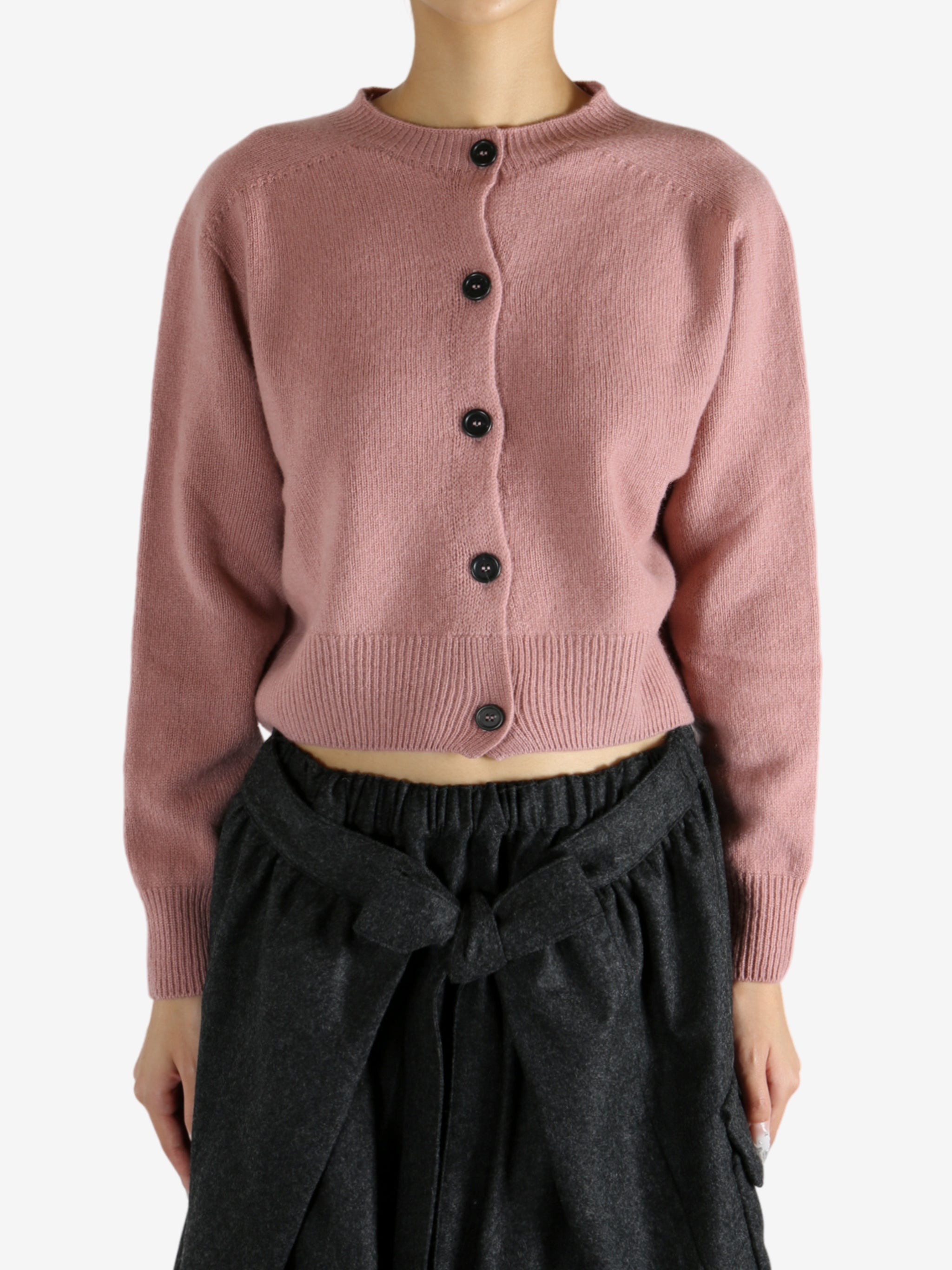 pink knitwear worn by a person, showing the knitwear fit