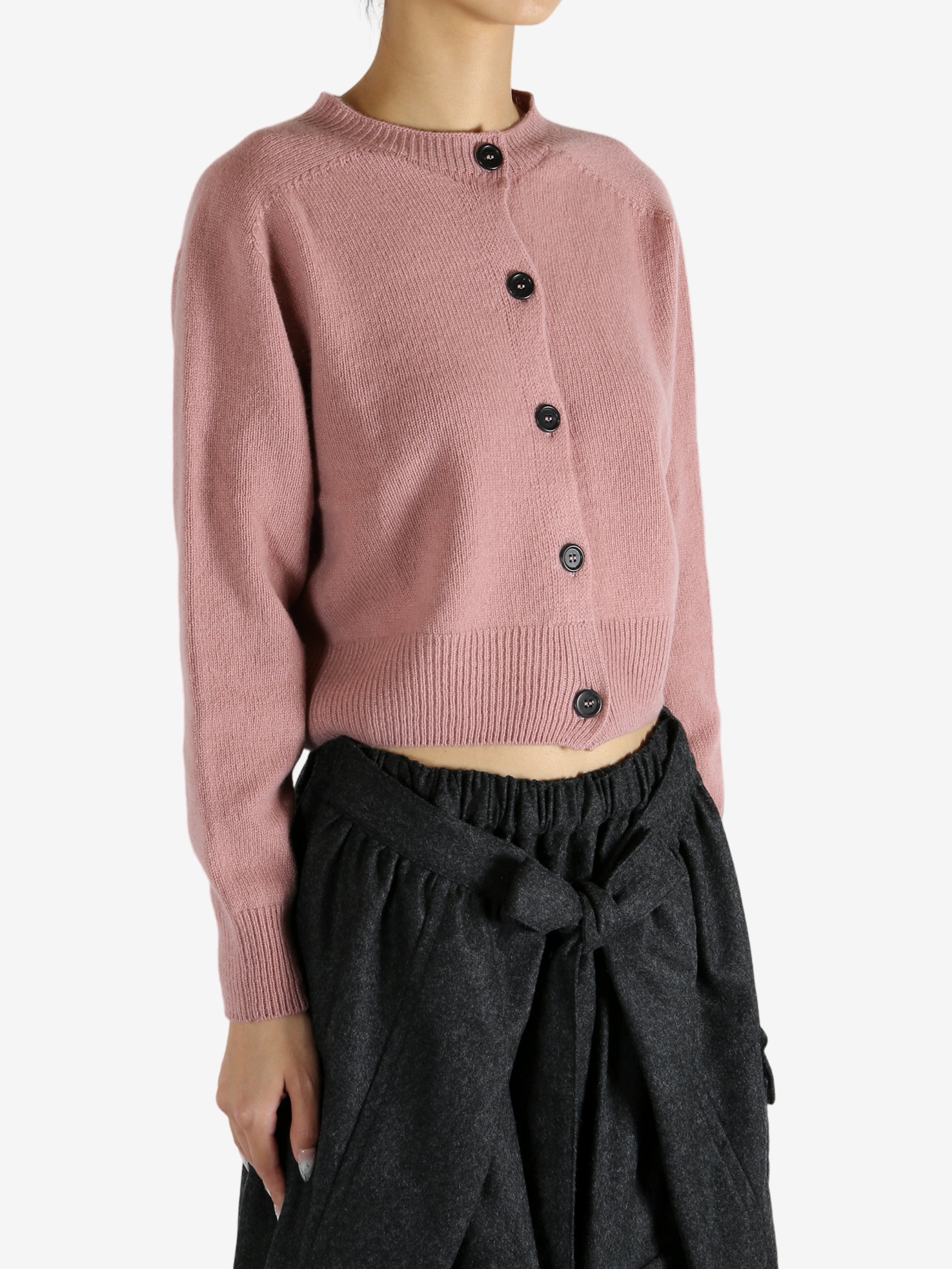 pink knitwear worn by a person, showing the knitwear fit