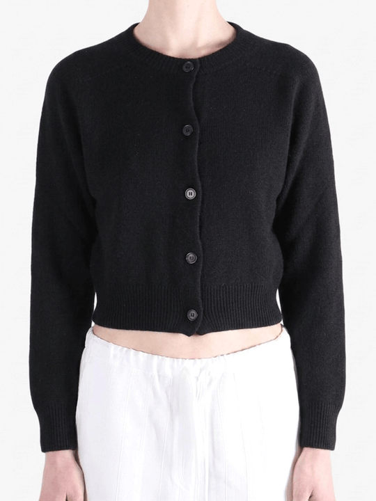 Black knitwear worn by a person, showing the knitwear's fit