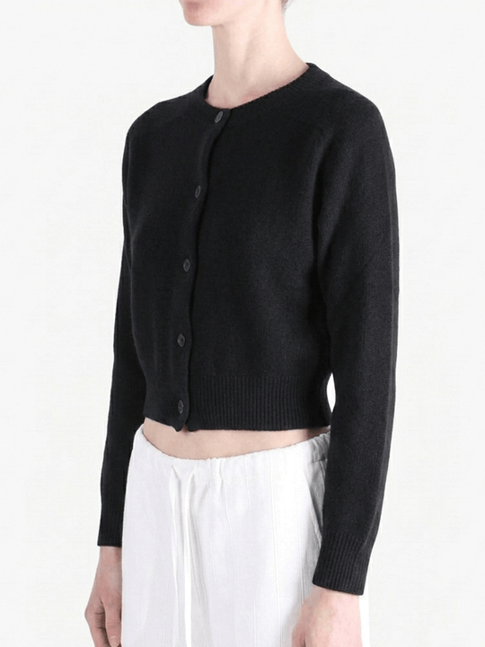 Black knitwear worn by a person, showing the knitwear's fit