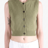 Green top worn by a person, showing the top fit