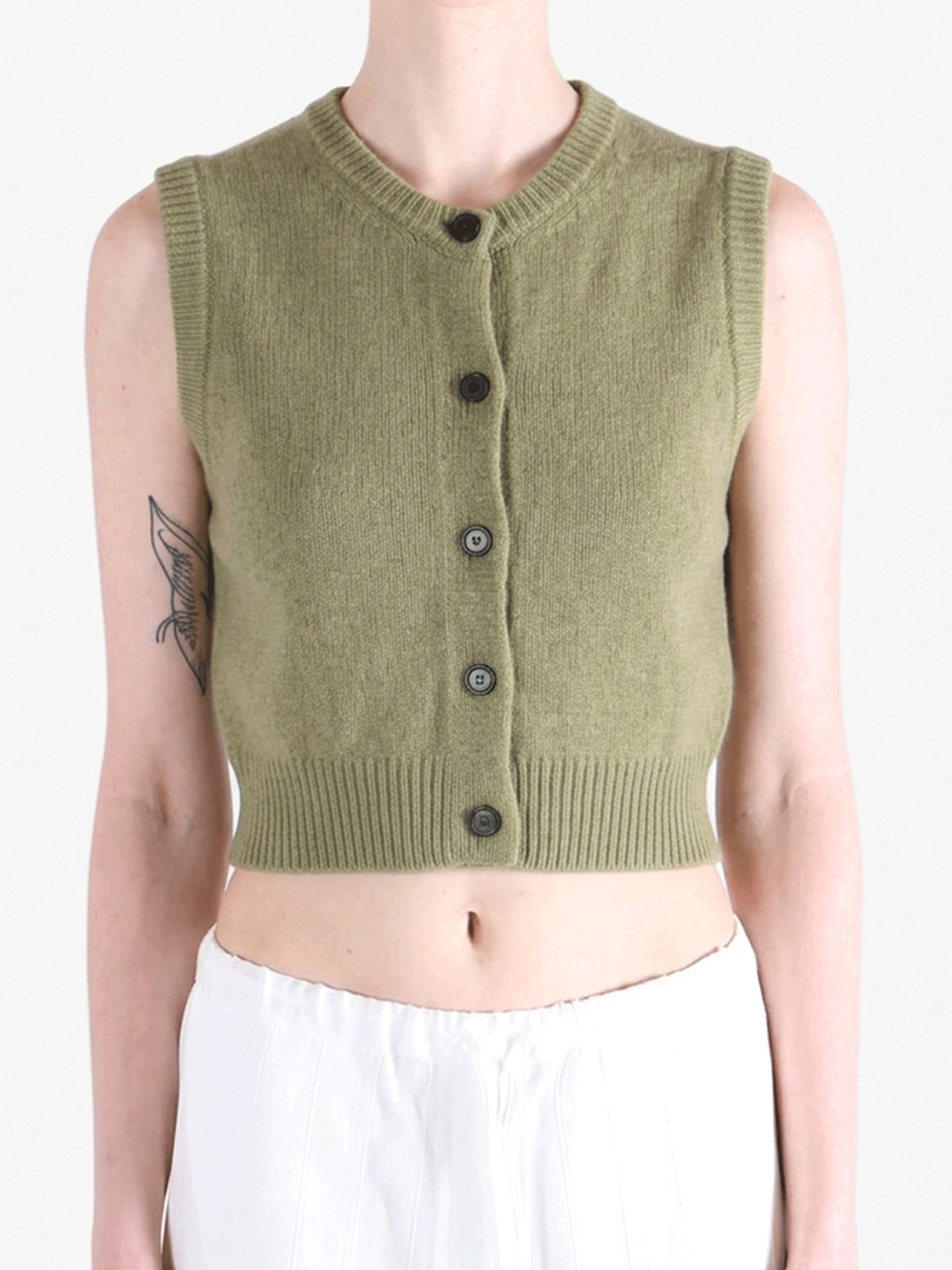 Green top worn by a person, showing the top fit