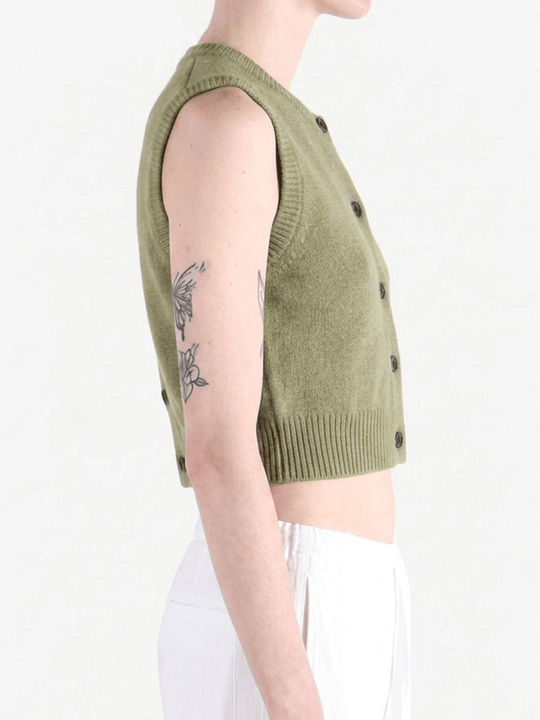 Green top worn by a person, side view