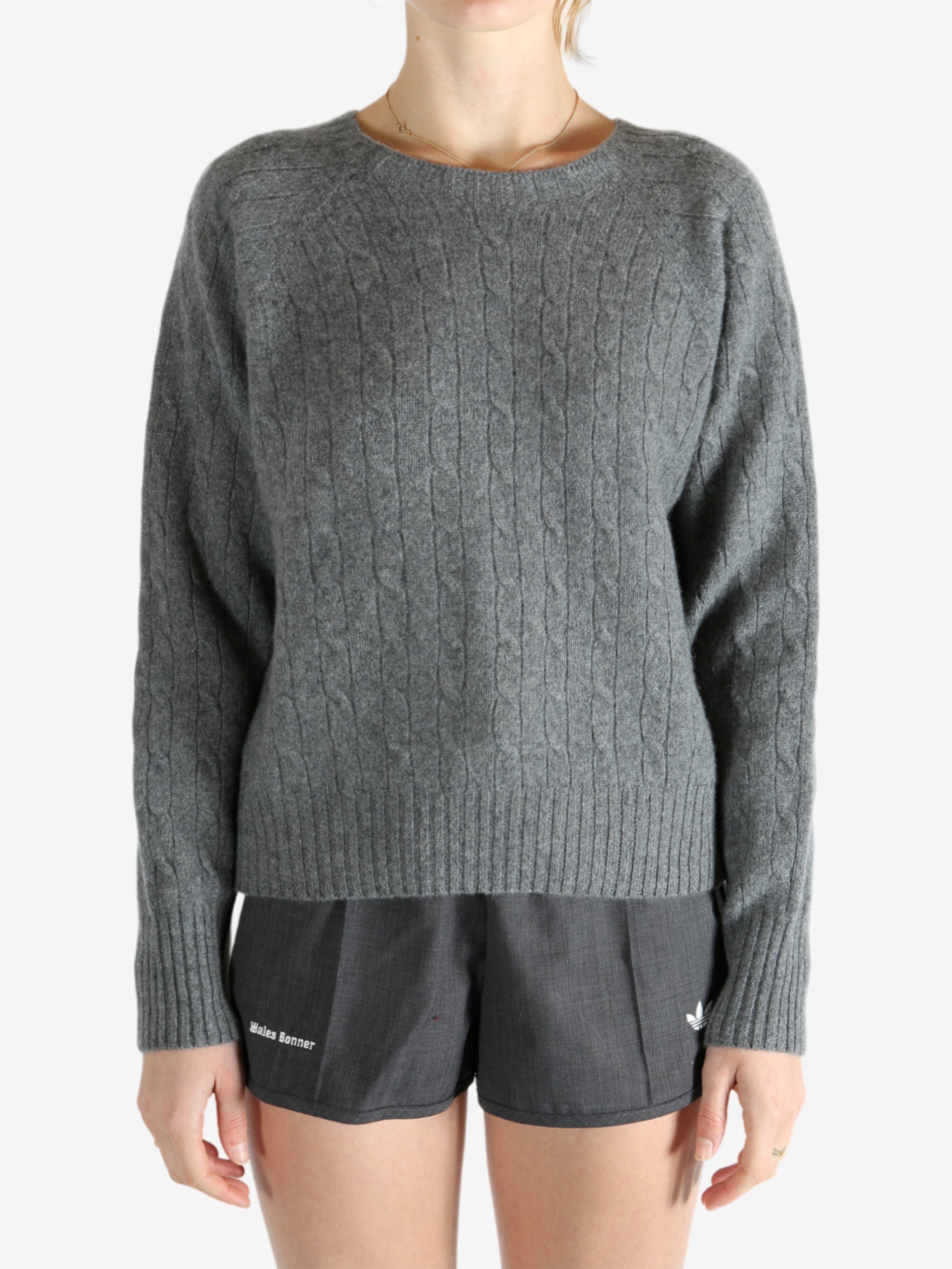Grey knitwear worn by a person, showing the knitwear fit
