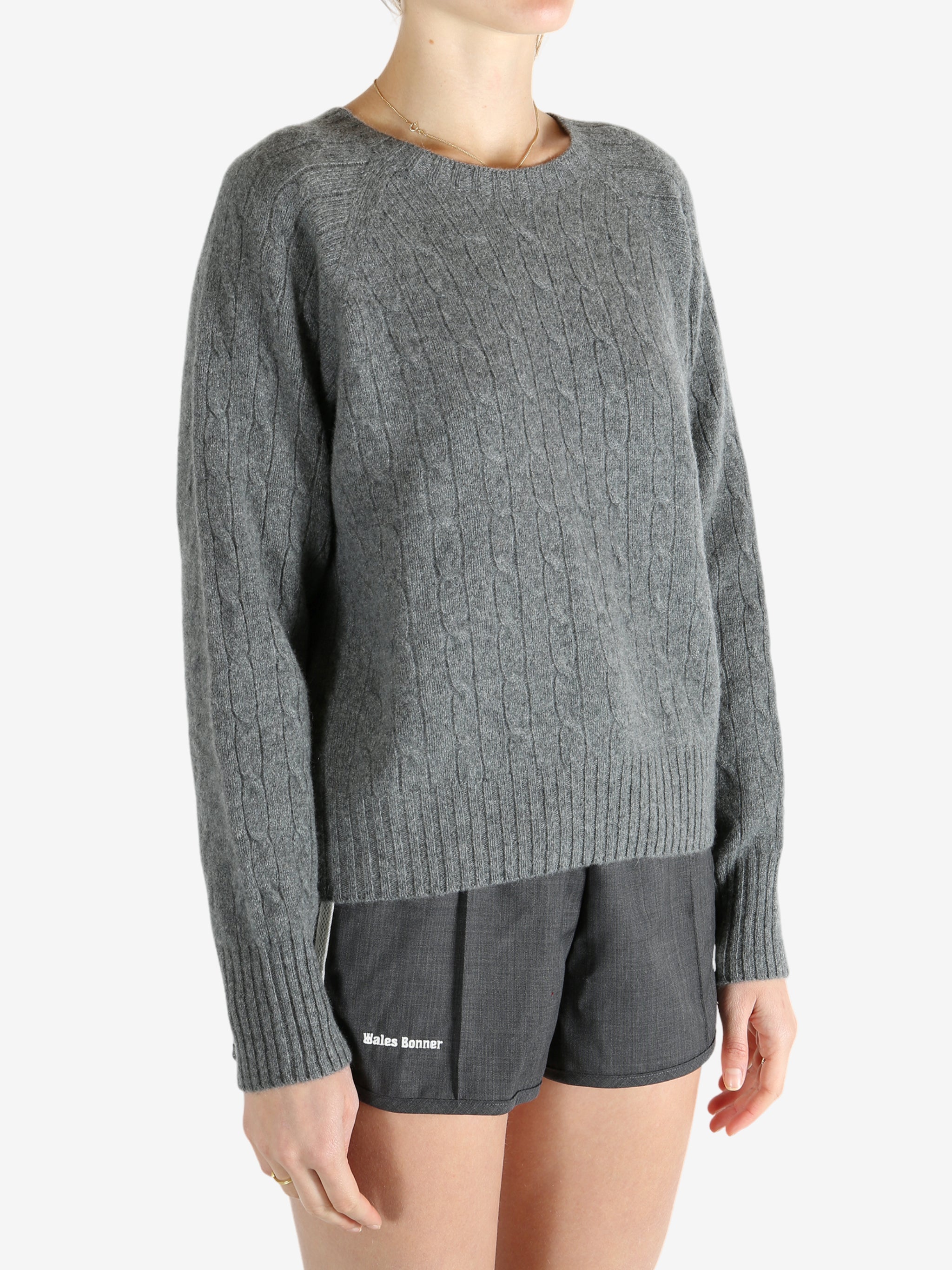 Grey knitwear worn by a person, showing the knitwear fit